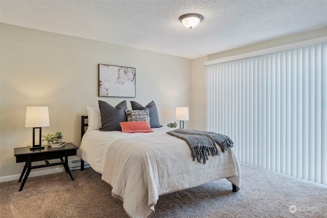 carpeted bedroom featuring a textured ceiling