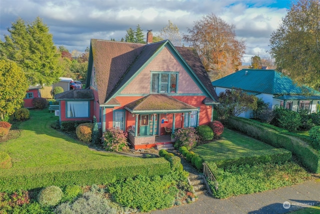 view of front of home featuring a front yard and a porch