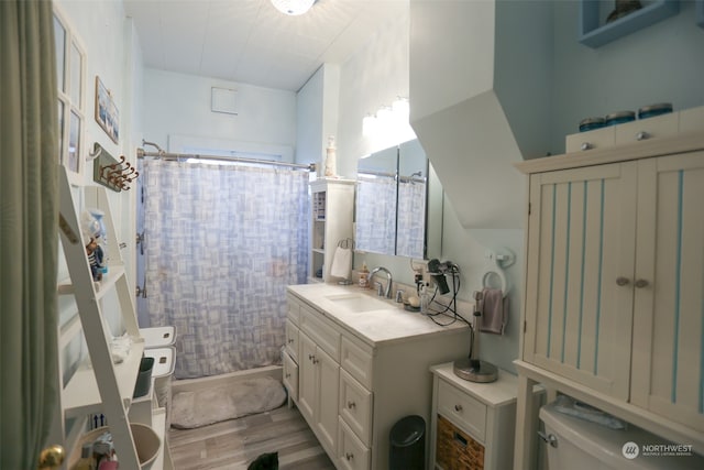 bathroom with vanity, hardwood / wood-style floors, a shower with curtain, and toilet