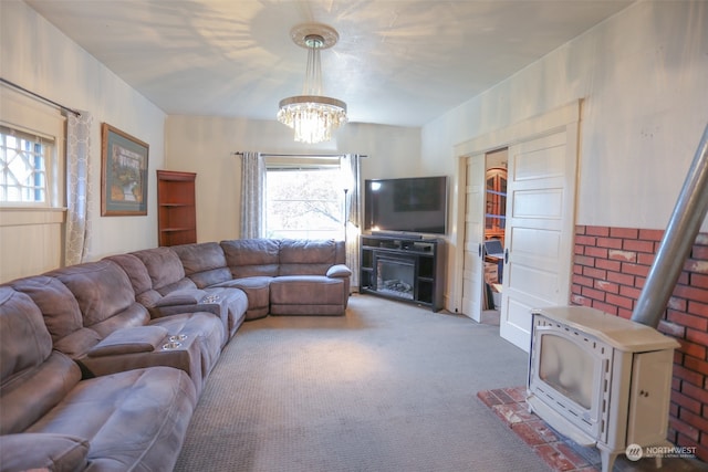 living room with a healthy amount of sunlight, carpet flooring, and a chandelier