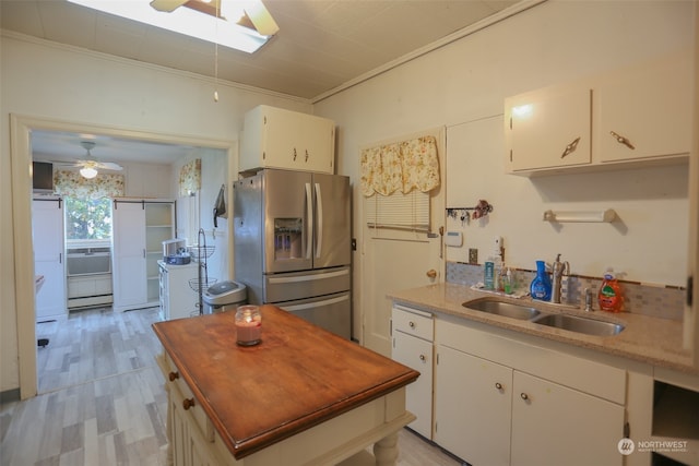 kitchen with crown molding, white cabinetry, and stainless steel refrigerator with ice dispenser