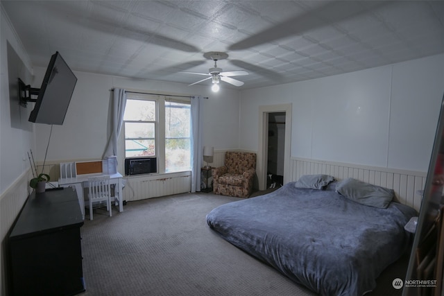 carpeted bedroom with radiator and ceiling fan