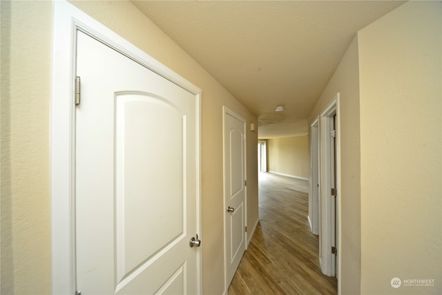 hallway with wood-type flooring