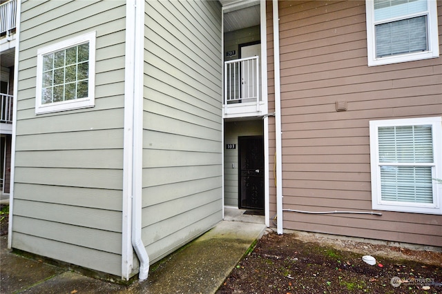 view of exterior entry featuring a balcony