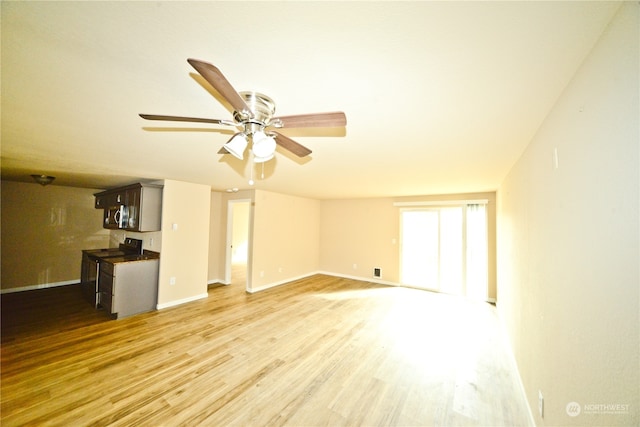 unfurnished living room with hardwood / wood-style floors and ceiling fan