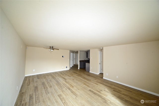 unfurnished living room with ceiling fan and light wood-type flooring