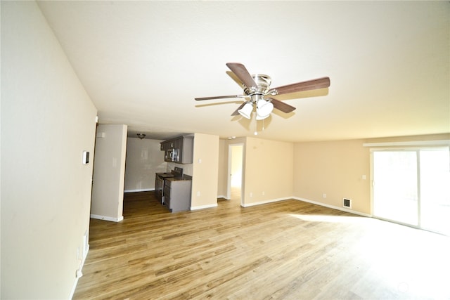 unfurnished living room featuring light wood-type flooring and ceiling fan