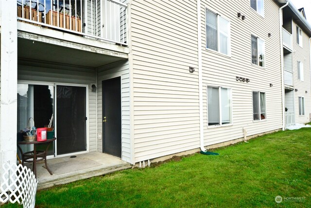 exterior space with a yard and a balcony