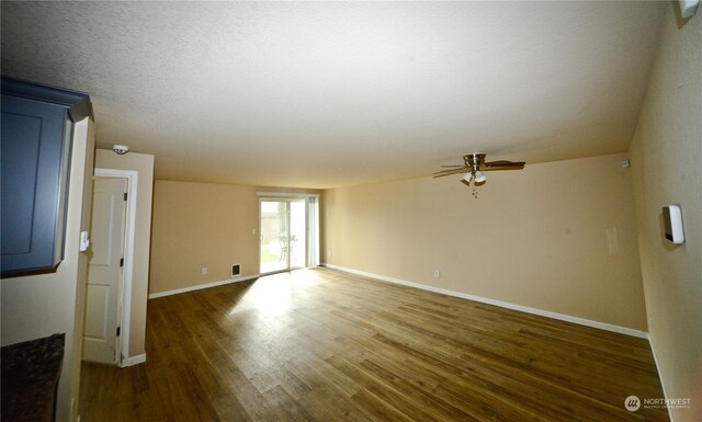 empty room featuring dark wood-type flooring and ceiling fan