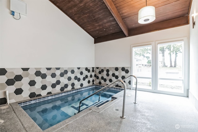 view of swimming pool featuring an indoor hot tub