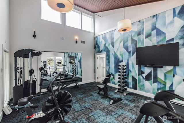 workout area with visible vents, baseboards, carpet, and wood ceiling