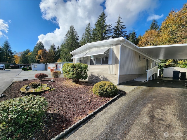 view of home's exterior featuring a carport and driveway