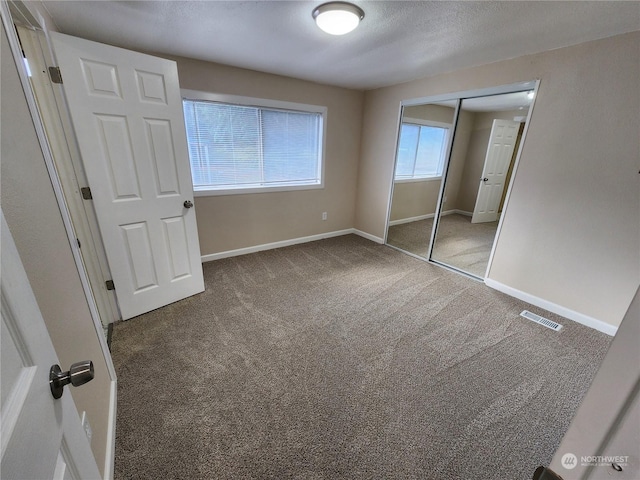 1111 Archwood Dr SW Unit 447, Olympia, WA 98502 - unfurnished bedroom with baseboards, a closet, visible vents, and carpet floors