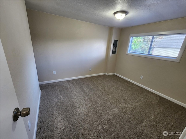 1111 Archwood Dr SW Unit 447, Olympia, WA 98502 - empty room with a textured ceiling, dark colored carpet, and baseboards