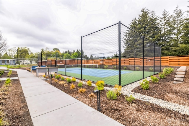 view of sport court featuring fence