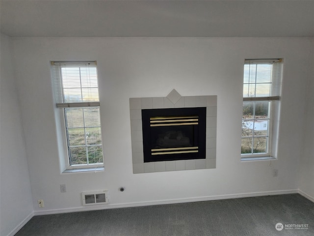 interior details featuring a fireplace and carpet floors