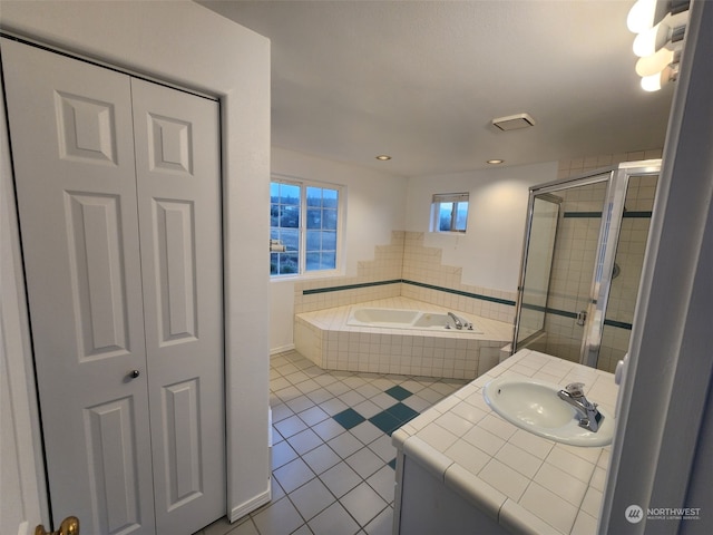 bathroom featuring independent shower and bath, vanity, and tile patterned floors