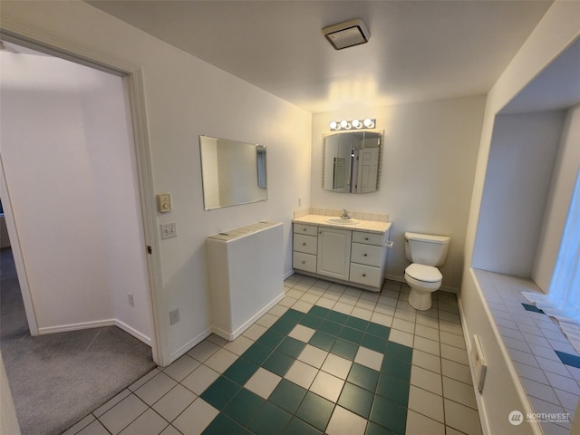 bathroom with vanity, tile patterned floors, and toilet