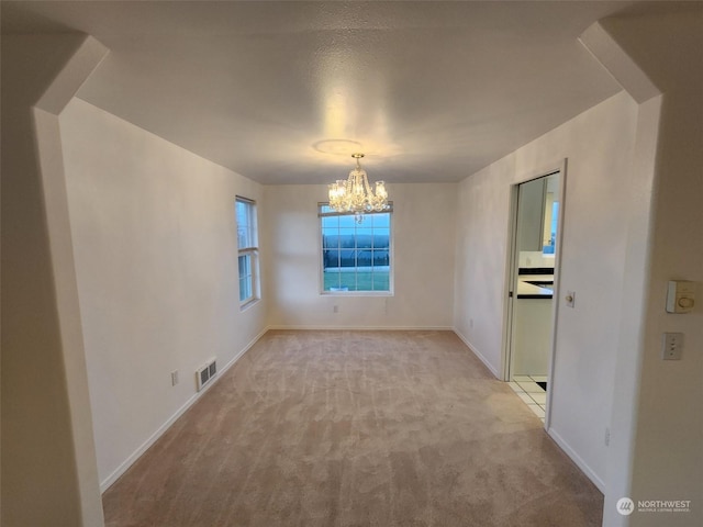 151 Rilla Ln, Sequim, WA 98382 - unfurnished room featuring a chandelier, carpet flooring, and baseboards