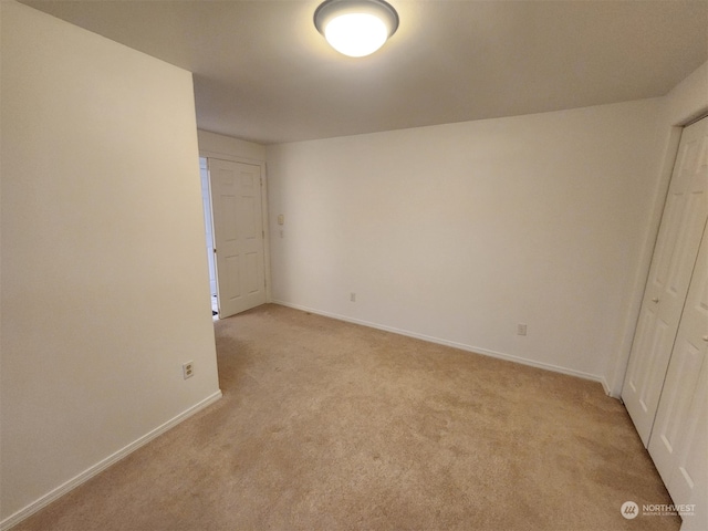 unfurnished bedroom featuring light carpet