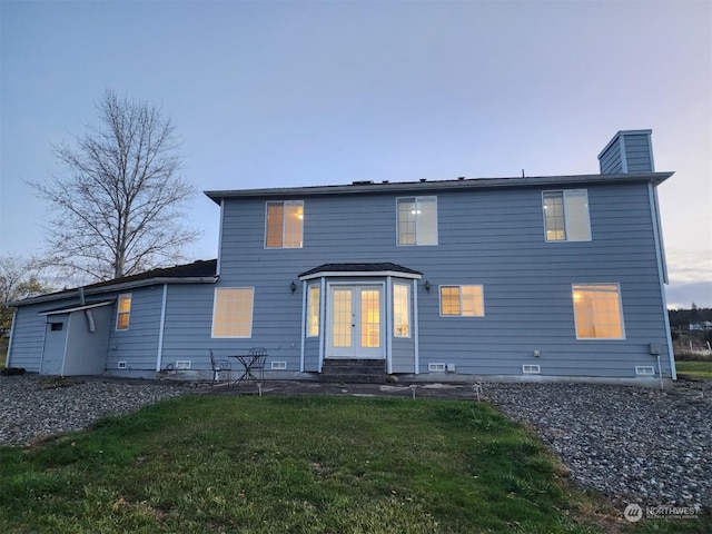 151 Rilla Ln, Sequim, WA 98382 - rear view of house featuring french doors, a yard, a chimney, and entry steps