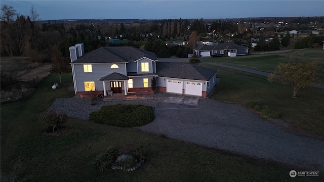 151 Rilla Ln, Sequim, WA 98382 - traditional-style home with gravel driveway, an attached garage, a chimney, and a front lawn