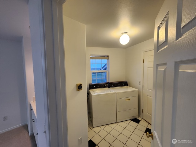 laundry area with light tile patterned floors, a water view, and washer and clothes dryer