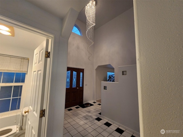 151 Rilla Ln, Sequim, WA 98382 - foyer featuring a towering ceiling, a textured wall, and tile patterned flooring