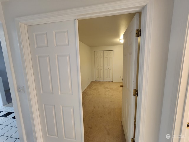 hallway featuring light colored carpet