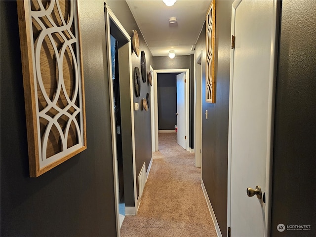 corridor with light colored carpet