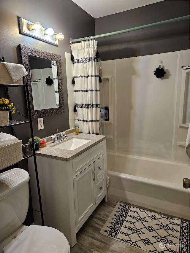 full bathroom with vanity, toilet, shower / bath combo with shower curtain, and hardwood / wood-style floors