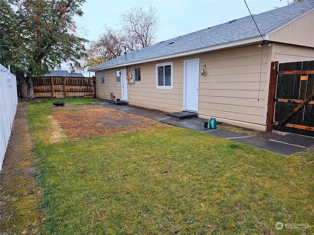 rear view of property with a yard