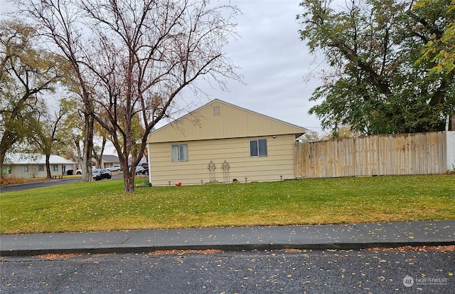 view of side of home with a lawn