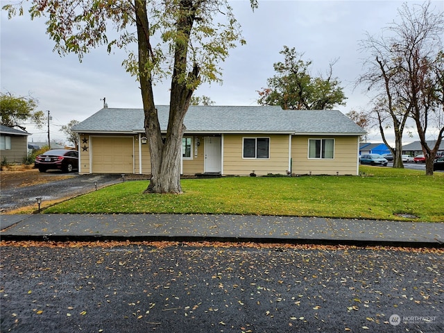 view of front of house with a front yard and a garage