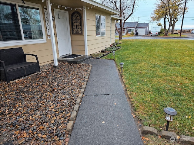 property entrance with a lawn