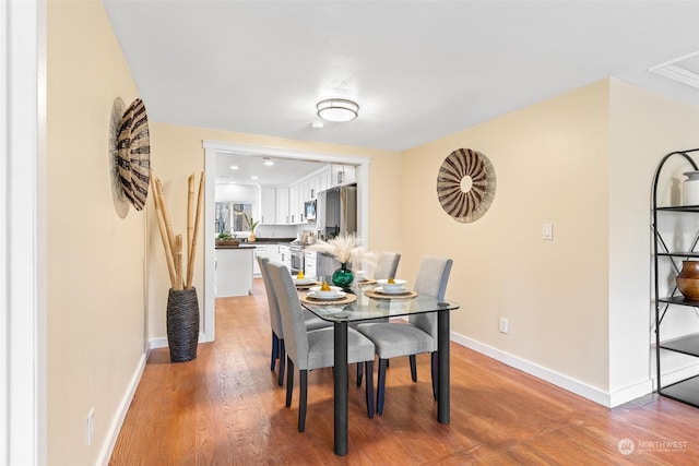 dining space featuring light wood-type flooring