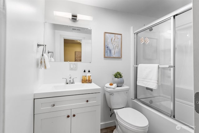 full bathroom with vanity, toilet, and combined bath / shower with glass door