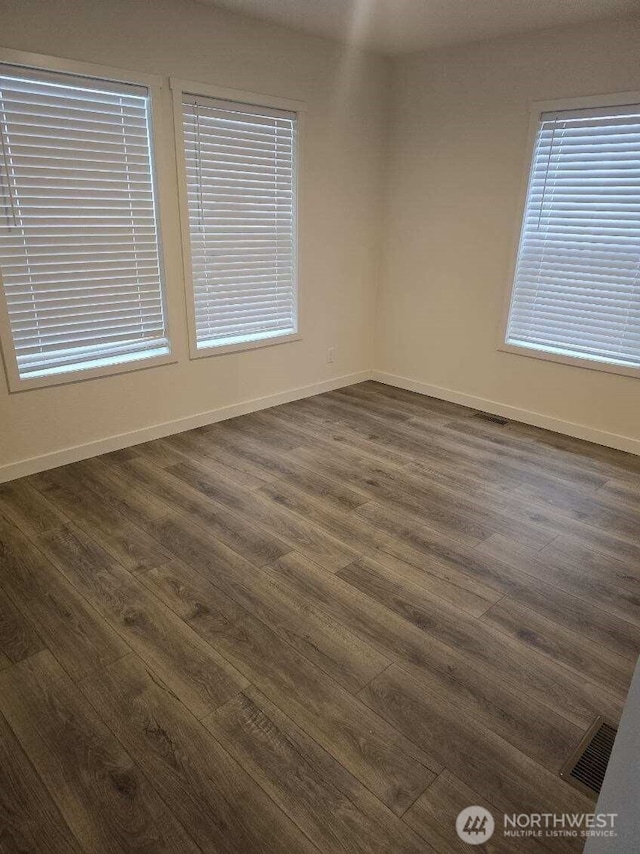 1011 N 34th Ave Unit 59, Yakima, WA 98902 - spare room featuring dark wood-type flooring and baseboards
