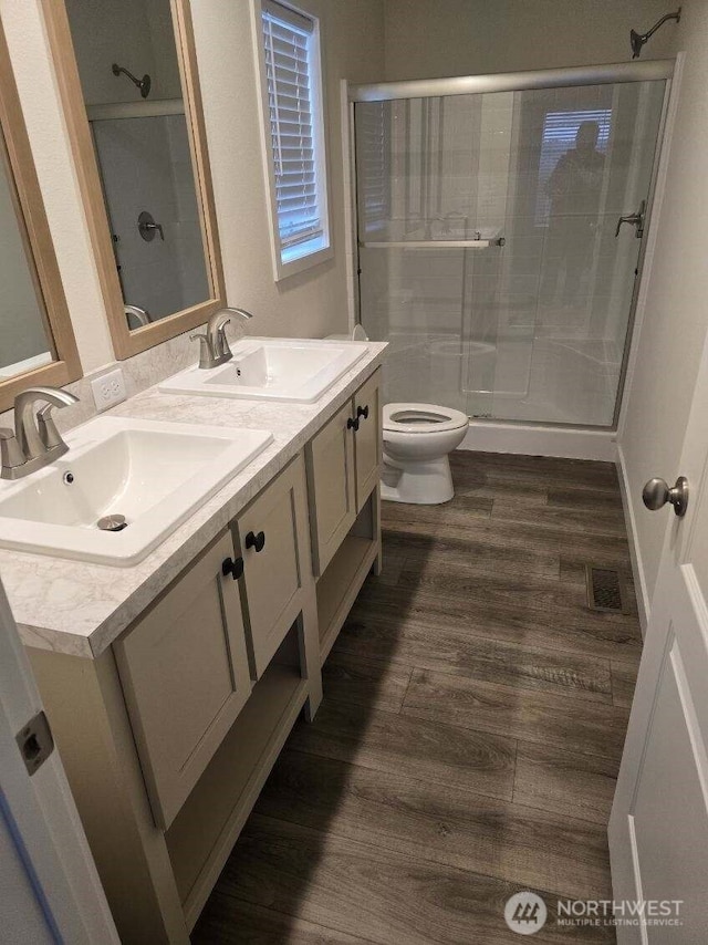 1011 N 34th Ave Unit 59, Yakima, WA 98902 - full bathroom with toilet, double vanity, a stall shower, and wood finished floors