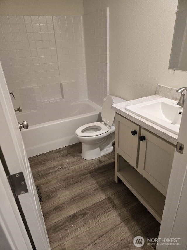 1011 N 34th Ave Unit 59, Yakima, WA 98902 - bathroom with vanity, toilet, wood finished floors, and shower / bath combination