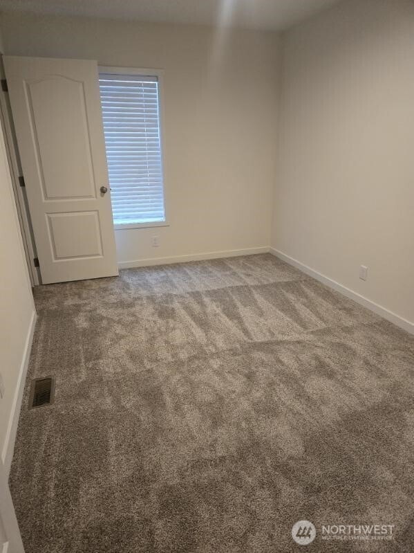1011 N 34th Ave Unit 59, Yakima, WA 98902 - carpeted spare room with baseboards