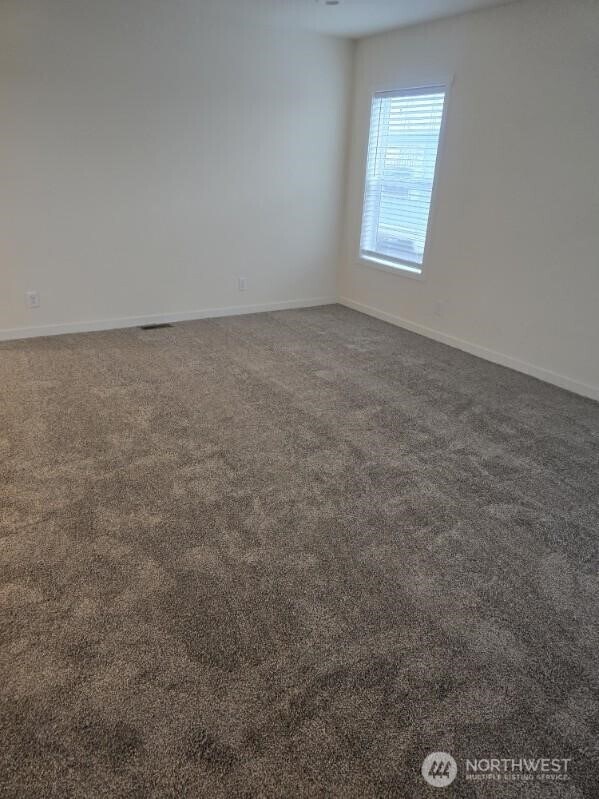 1011 N 34th Ave Unit 59, Yakima, WA 98902 - carpeted empty room featuring baseboards