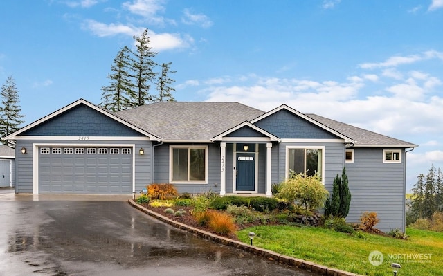 view of front of house featuring a garage and a front yard