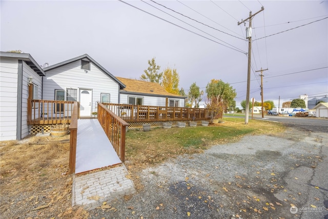 back of house featuring a wooden deck