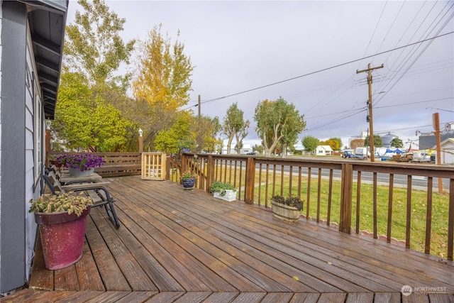 wooden deck featuring a yard