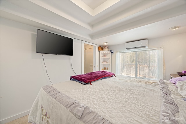 bedroom with a wall mounted air conditioner and carpet floors