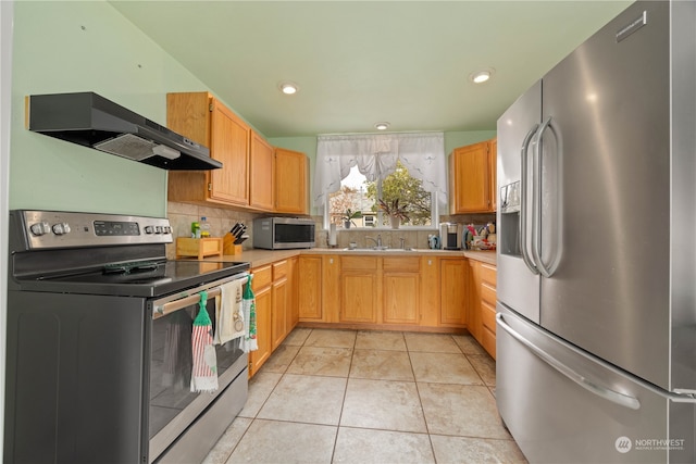 kitchen with exhaust hood, light tile patterned floors, appliances with stainless steel finishes, backsplash, and sink