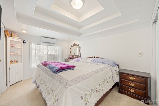 bedroom featuring a wall mounted AC, light carpet, and a tray ceiling