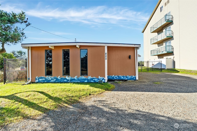 exterior space with a lawn and a balcony