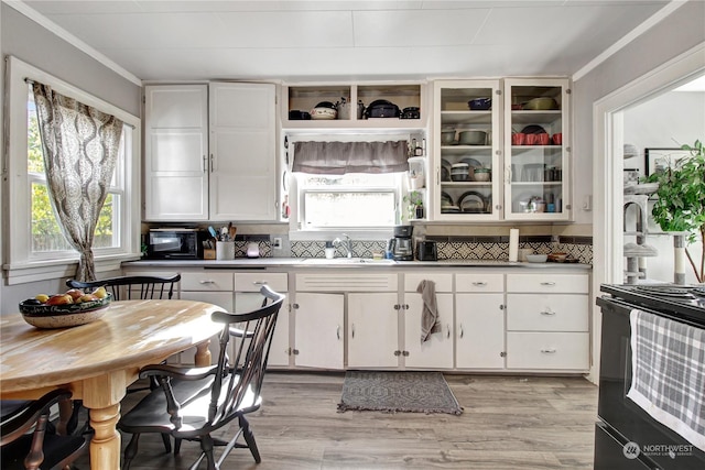 730S Emens Ave, Darrington, WA 98241 - kitchen with a sink, white cabinetry, black appliances, light wood-style floors, and ornamental molding